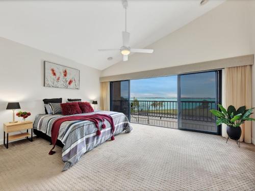 a bedroom with a bed and a large window at Kudoya Waters in Yarrawonga