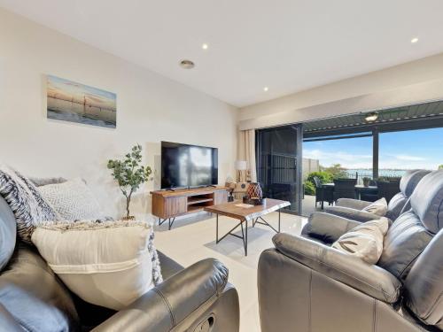 a living room with a couch and a tv at Kudoya Waters in Yarrawonga