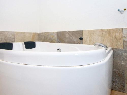 a white bath tub in a bathroom at 16 person holiday home in Ansager-By Traum in Ansager