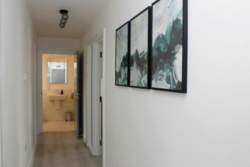 a hallway of a house with a painting on the wall at The Peaks Three Bed Apartment in Aviemore