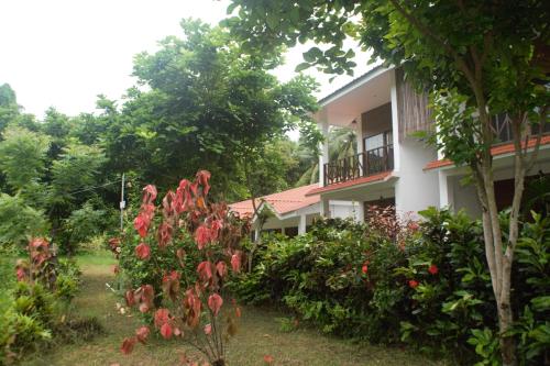 a building with a bunch of flowers in front of it at Hotel Exotica Squares in Neil Island