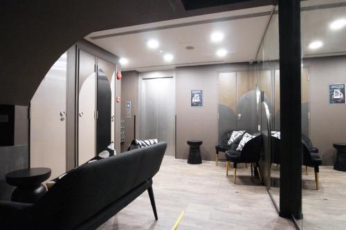a hair salon with black and white chairs and mirrors at ST Signature Bugis Beach in Singapore