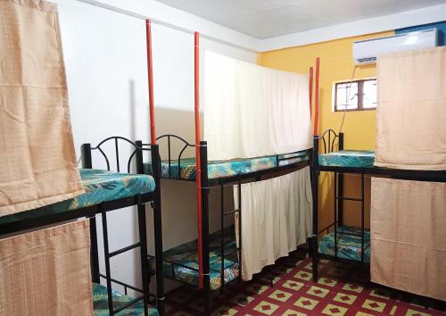 eine Gruppe von 3 Etagenbetten in einem Zimmer in der Unterkunft Footprints Hostel in Coron