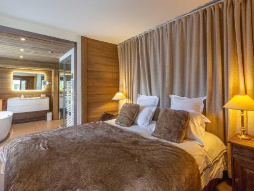 a bedroom with a large bed with two pillows at Appartement de standing avec balcon ensoleillé, 3 chambres, au cœur de Val-d'Isère - FR-1-694-322 in Val dʼIsère