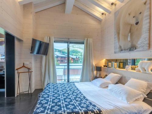 a bedroom with a large bed with a bear on the wall at Prestige et luxe au cœur de Val-d'Isère, proche des pistes - FR-1-694-323 in Val dʼIsère