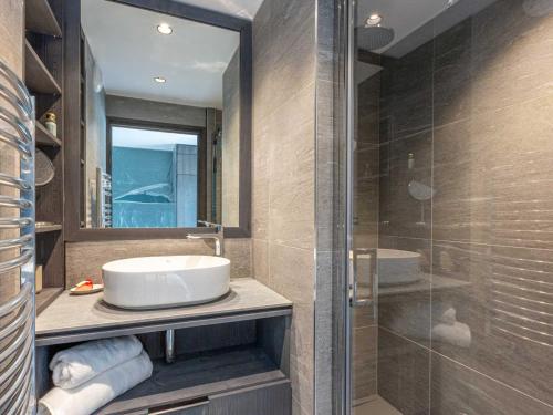 a bathroom with a sink and a glass shower at Appartement Val-d'Isère, 5 pièces, 8 personnes - FR-1-694-325 in Val-d'Isère