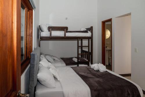 a bedroom with a large bed with two bunk beds at HOTEL ALTIPLANO VILLA DE LEYVA in Villa de Leyva