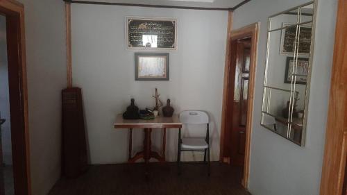 a room with a small table and a chair in it at Villa Dikawah Ratu 1000m2 in Jabon