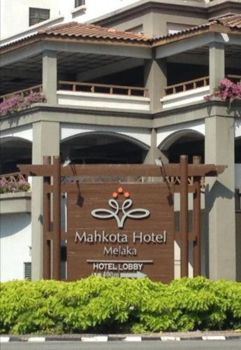 a sign for a malibu hotel in front of a building at Costa Mahkota Suites Malacca Central By Nestcove in Melaka