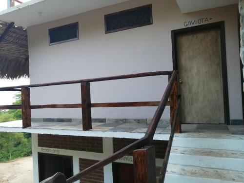 a house with a staircase leading up to the front door at HOTEL AVE FENIX in Mazunte