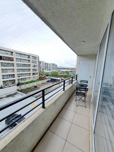 an apartment balcony with a view of a city at Comodo Dpto. 4to piso - 2P/2B Excelente Conectividad/Buen Sector - Brisas Del Sol in Talcahuano