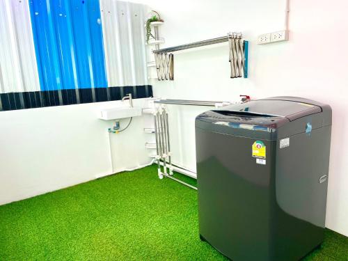 a bathroom with a trash can and green grass at k4 be chill *Wongwianyai BTS_80m*Family&Friend* in Godown