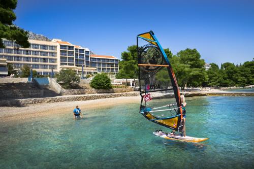 a person riding a wind sail in the water at Aminess Grand Azur Hotel in Orebić