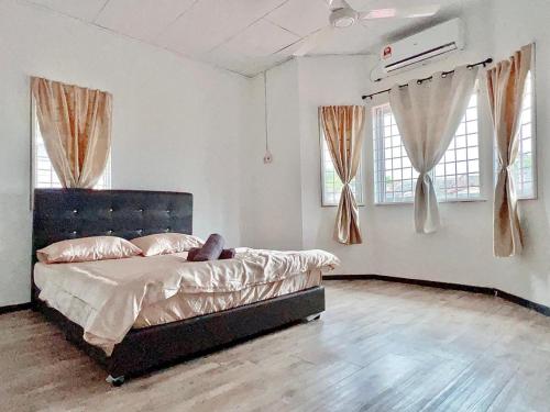 a bedroom with a bed in a room with windows at You can sleep well in Sungai Petani