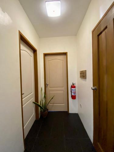 a hallway with two doors and a fire hydrant at LRS Apartment in Basdiot
