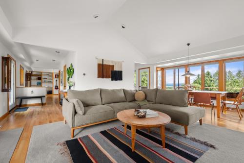 a living room with a couch and a table at Relaxing Catskill Escape- Mountain Views - Hot Tub - Fire Pit - Heated Pool in Catskill