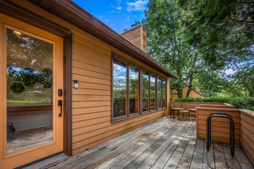 a porch of a house with a wooden deck at Relaxing Catskill Escape- Mountain Views - Hot Tub - Fire Pit - Heated Pool in Catskill