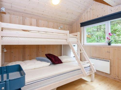 a bedroom with two bunk beds in a cabin at 6 person holiday home in Oksbøl-By Traum in Oksbøl