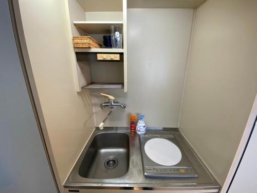 a small bathroom with a sink in a caravan at Piazza-U Yutenji by Tranova in Tokyo