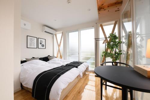 a bedroom with a large bed and a table at 和光荘 Harmonious Light West in Hakone