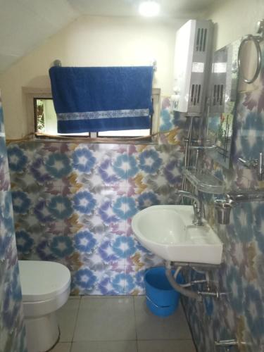 a bathroom with a sink and a toilet at Unique point home stay in Nagarkot