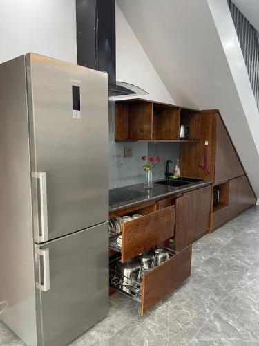 a kitchen with a stainless steel refrigerator and a sink at Wyndham Luxury Villa Vân Đồn 
