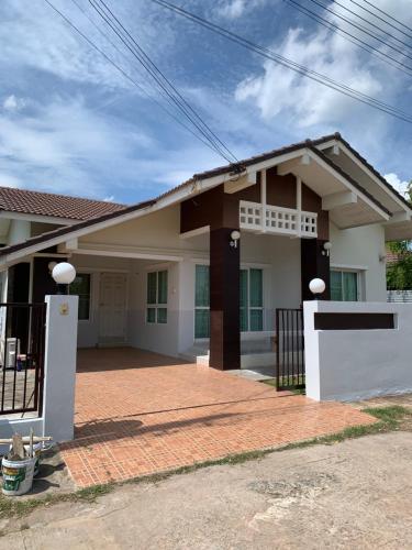 a house with a brick driveway in front of it at Baan Khun House in Nakhon Ratchasima