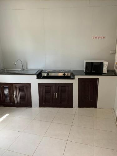 a kitchen with a sink and a counter top at Baan Khun House in Nakhon Ratchasima