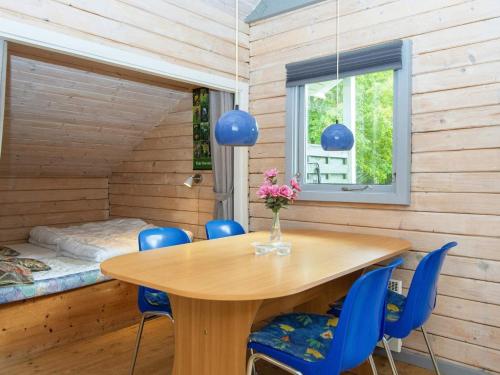 a dining room with a wooden table and blue chairs at 4 person holiday home in Hovborg-By Traum in Hovborg