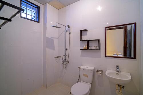 a bathroom with a toilet and a sink and a shower at Hoi An Viet House Homestay in Hoi An