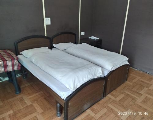 a bed with two white pillows on top of it at Kedar Heights Heli Resorts by StayApart in Phata