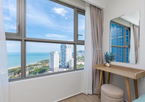 a room with a desk and a large window at The Sóng Apartment - Nhà Của Kim in Vung Tau