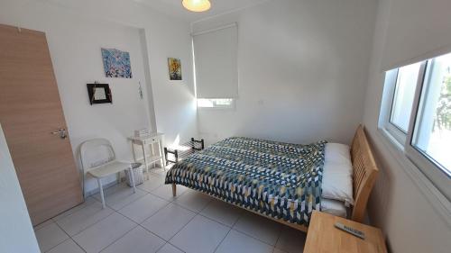 a small bedroom with a bed and a window at Relaxing Avra Villa with Private Pool & Garden Near Protaras in Paralimni