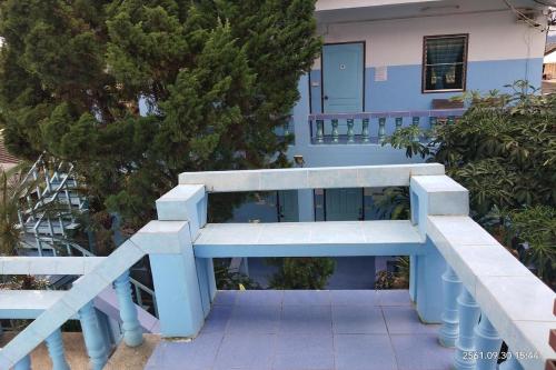 a blue bench sitting in front of a house at Blue House Pai in Pai