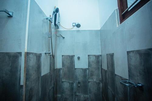 a shower stall in a bathroom with a shower at DR. Place in Hikkaduwa