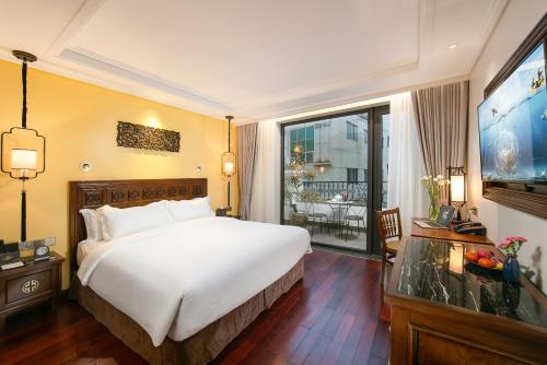 a hotel room with a bed and a large window at Lucien Hanoi Lakeside Hotel & Rooftop in Hanoi