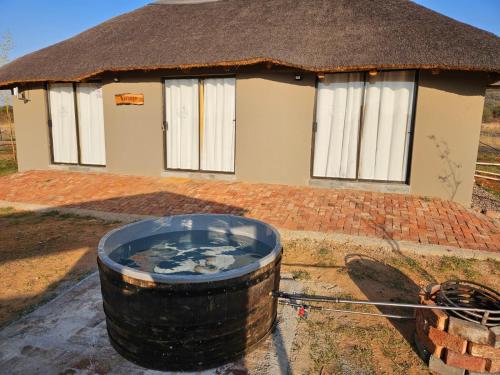 a house with a tub in front of a house at FLY FISHING PARADISE ON THE VAAL in Parys