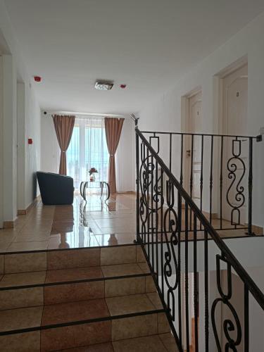a staircase in a white house with a stair case at VILA LA FORTALEZA in Haţeg