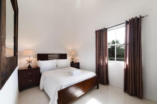 a bedroom with a bed and a large window at St James. Lantana 36 . Beautiful 2 bed apartment in Saint James