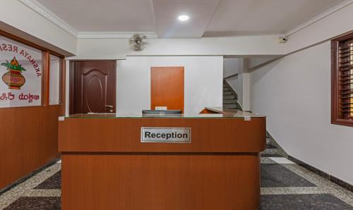 a reception desk with a registration sign in a room at Treebo Trend Akshaya Residency in Bangalore