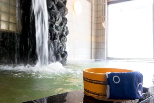 a coffee cup sitting on a table in front of a fountain at Shosenkaku in Nagano