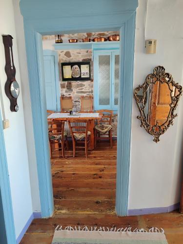 a dining room with a table and a mirror at Kokkari Traditional House in Kokkari