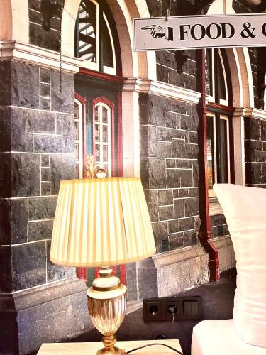 a lamp sitting on a table in front of a building at Designhotel Central Fulda in Fulda