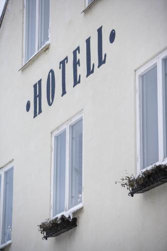 a sign for a hotel on the side of a building at Hotell Blå Blom in Gustavsberg