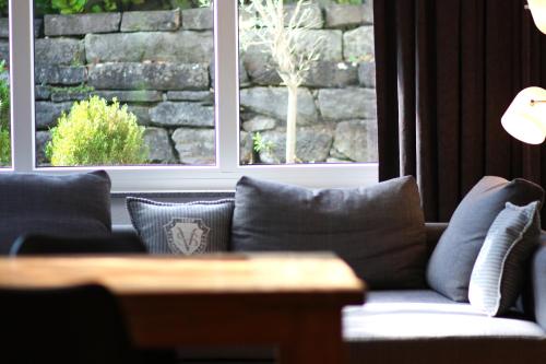 a living room with a couch and two windows at Konstanzer Ferienwohnungen in Konstanz