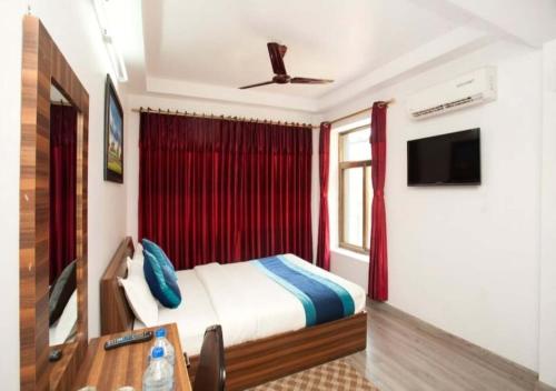 a bedroom with a bed and a table and a tv at Three Brothers Apartment and Hotel in Kathmandu