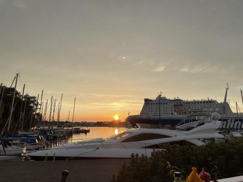 a cruise ship is docked in a harbor with boats at Meerlust Travemünde in Travemünde
