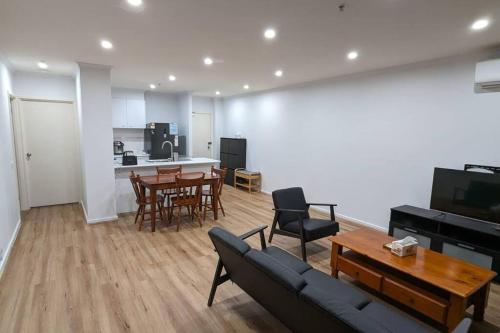 a living room with a couch and a table at 3 bedroom condo opposite casino. in Melbourne