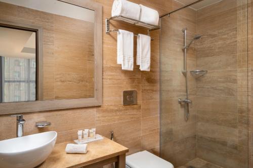 a bathroom with a sink and a shower at Republica Hotel Yerevan in Yerevan