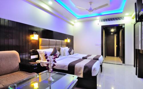 a hotel room with a bed and a couch at Crystal Ganga Heights 5 Min from Har Ki Pauri in Haridwār